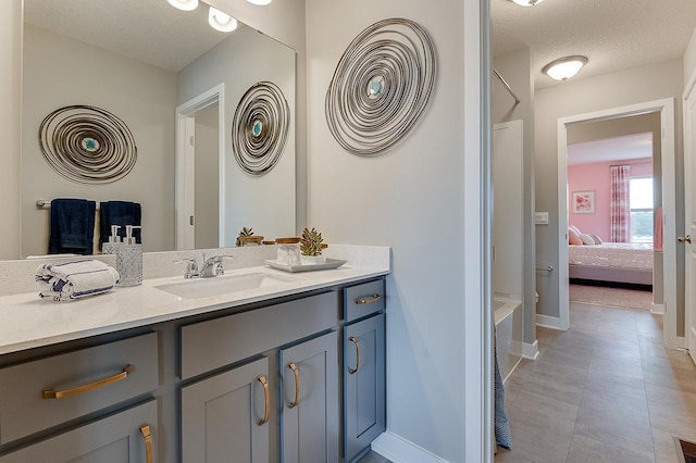 bathroom featuring vanity, a textured ceiling, and tile patterned floors