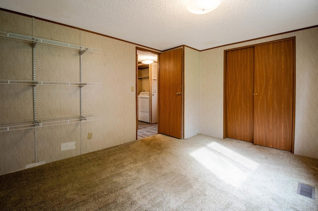 unfurnished bedroom featuring light carpet, a textured ceiling, and a closet