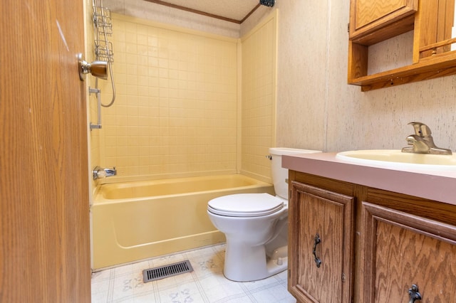 full bathroom with a textured ceiling, vanity, toilet, tile patterned floors, and tiled shower / bath combo