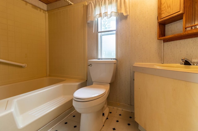 full bathroom featuring tile patterned floors, toilet, tiled shower / bath combo, and vanity