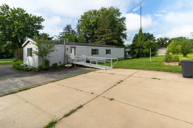 rear view of house featuring a lawn