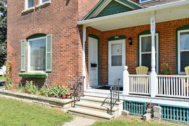 view of exterior entry featuring a porch