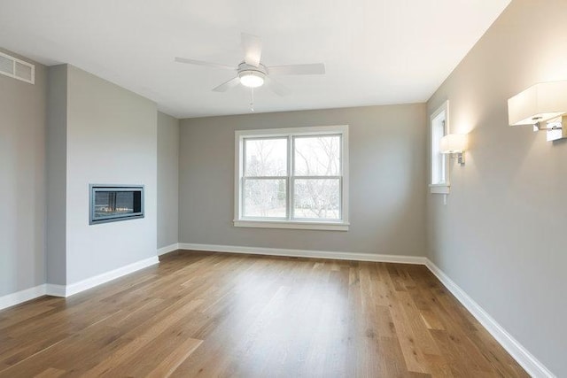 interior space featuring wood-type flooring and ceiling fan