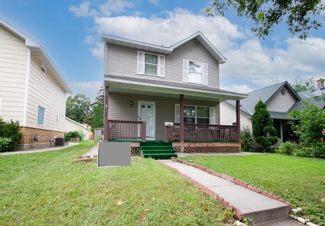 view of front of property with a front lawn, covered porch, and central air condition unit