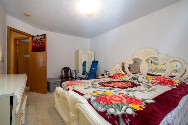 bedroom with a textured ceiling and carpet flooring