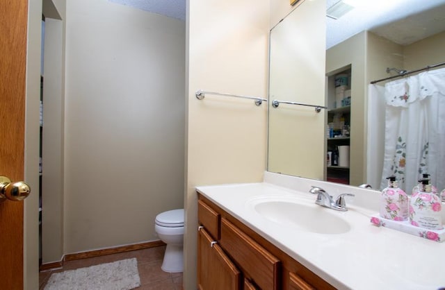 bathroom featuring toilet, tile patterned flooring, vanity, a textured ceiling, and curtained shower