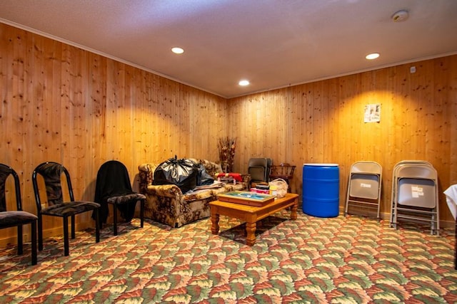 interior space featuring wood walls, carpet, and crown molding