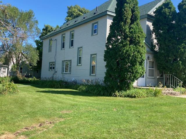 back of house with a lawn