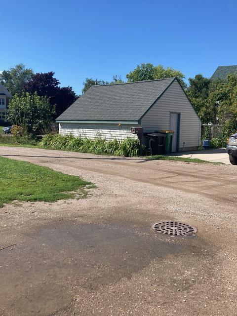 view of property exterior with a shingled roof