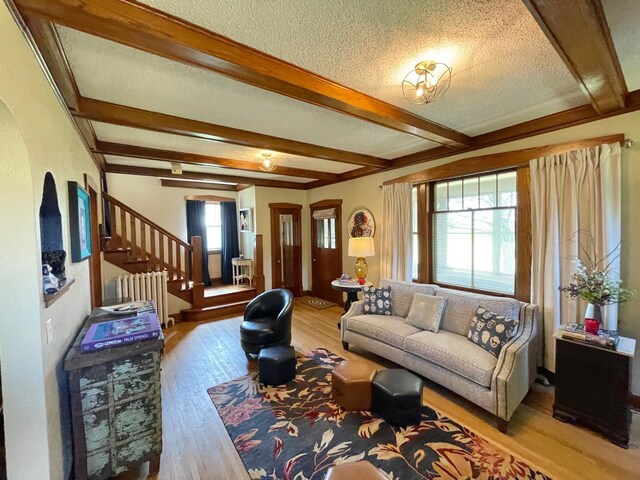 38364 200th St, Springfield, MN 56087 - living area with radiator, beamed ceiling, stairs, and wood finished floors