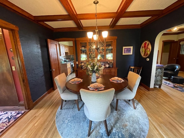 dining room with light hardwood / wood-style flooring, beam ceiling, and coffered ceiling