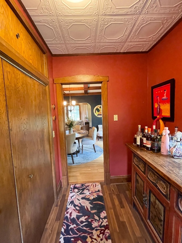 38364 200th St, Springfield, MN 56087 - corridor with baseboards, an ornate ceiling, wood finished floors, and a notable chandelier