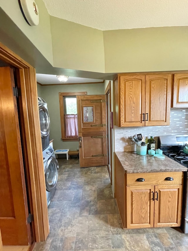 38364 200th St, Springfield, MN 56087 - laundry room with stacked washing maching and dryer, stone finish floor, baseboards, and laundry area