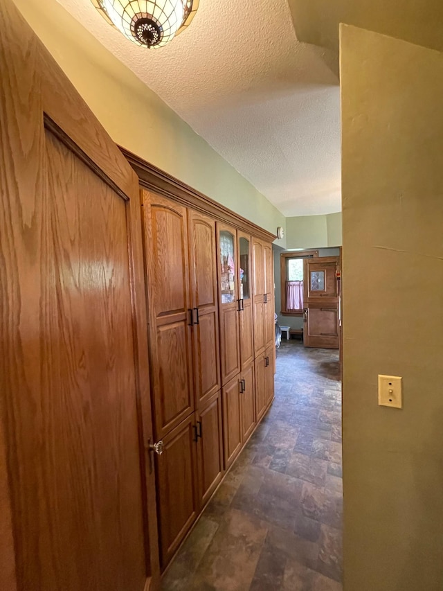 hall with a textured ceiling