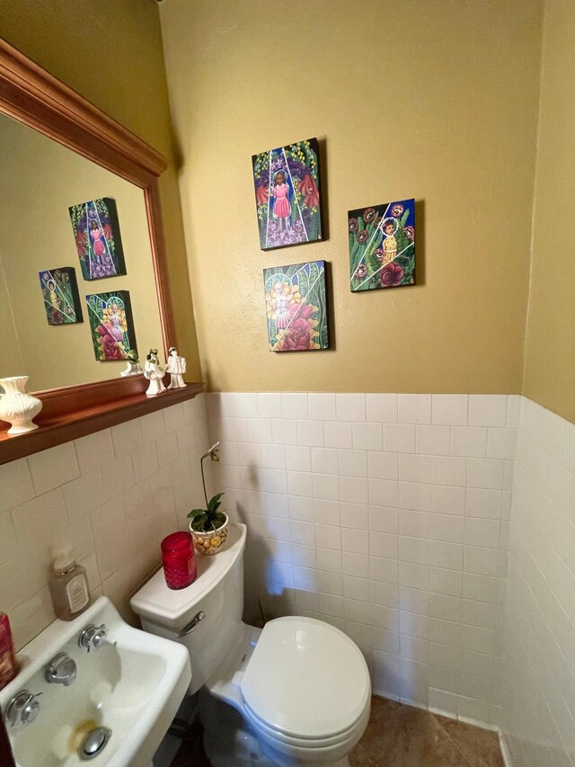 38364 200th St, Springfield, MN 56087 - bathroom with toilet, tile walls, a sink, and a wainscoted wall