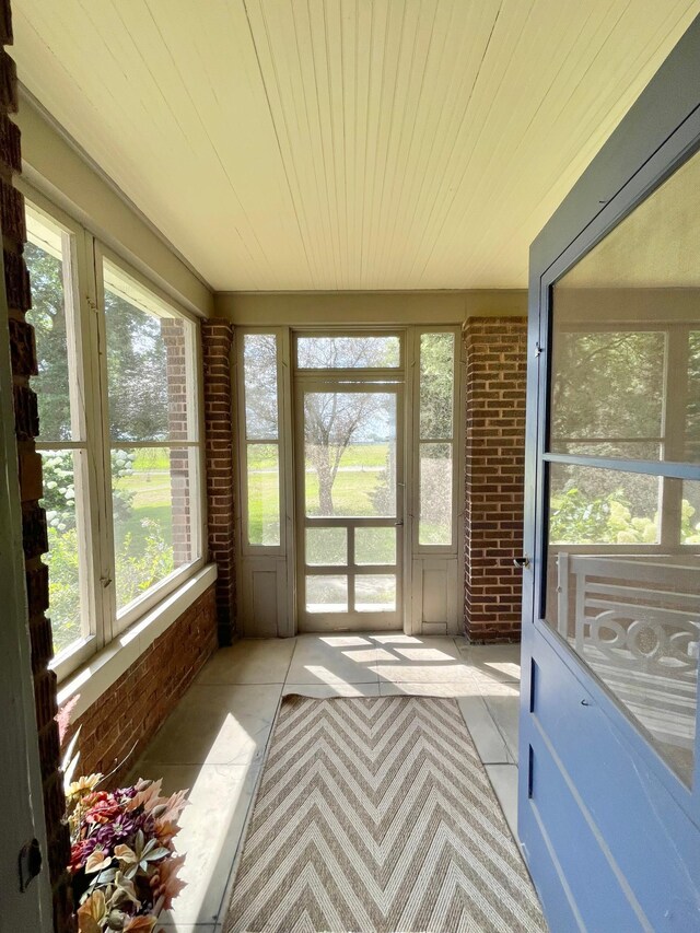 38364 200th St, Springfield, MN 56087 - unfurnished sunroom featuring brick wall and wooden ceiling