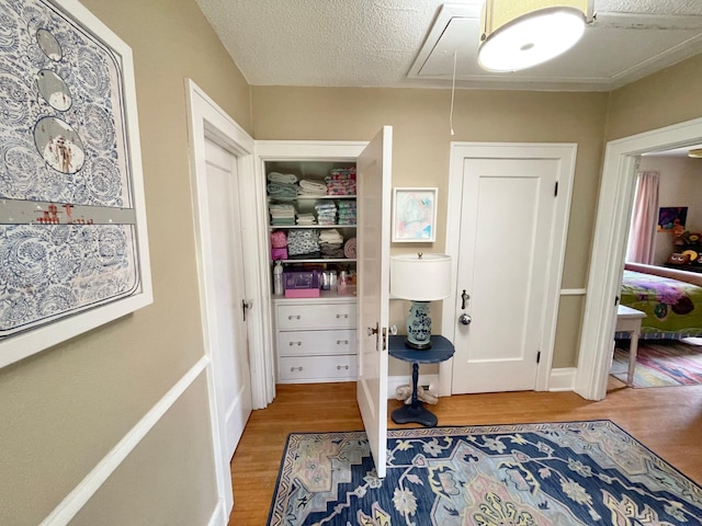 interior space featuring a textured ceiling and hardwood / wood-style floors