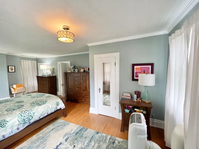 38364 200th St, Springfield, MN 56087 - bedroom with baseboards, ornamental molding, and wood finished floors