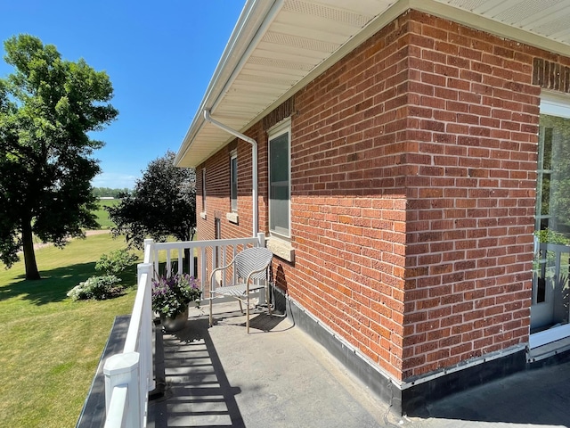 38364 200th St, Springfield, MN 56087 - view of side of home featuring brick siding and a lawn