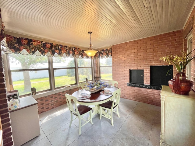 sunroom / solarium featuring wood ceiling and a water view