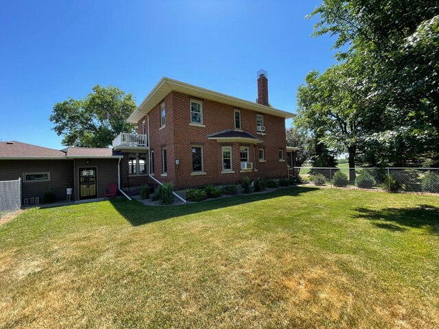 38364 200th St, Springfield, MN 56087 - back of house featuring a lawn, brick siding, fence, and a chimney
