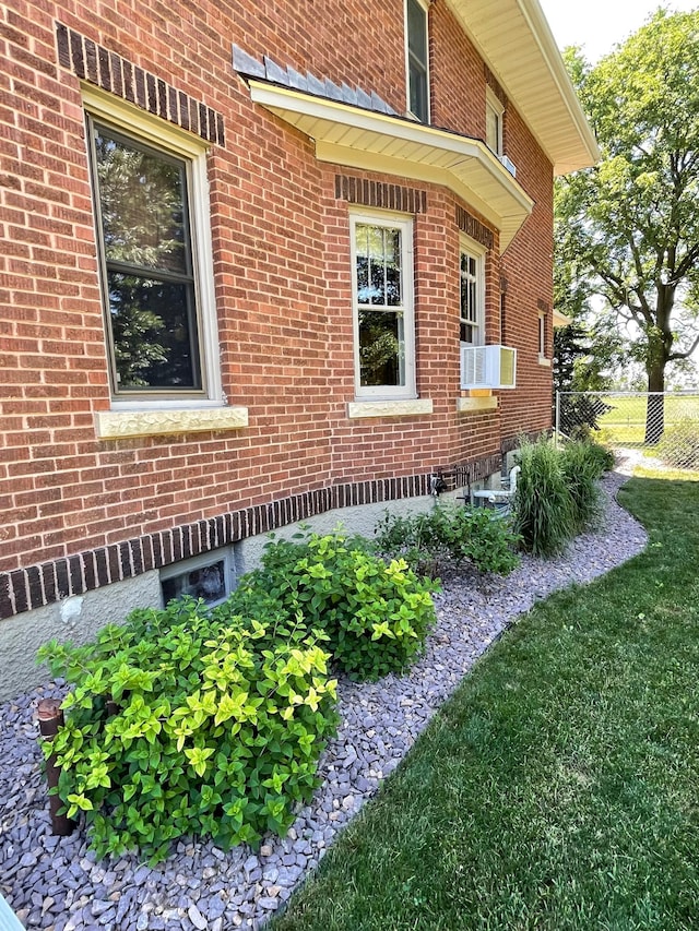 view of property exterior featuring a lawn and cooling unit