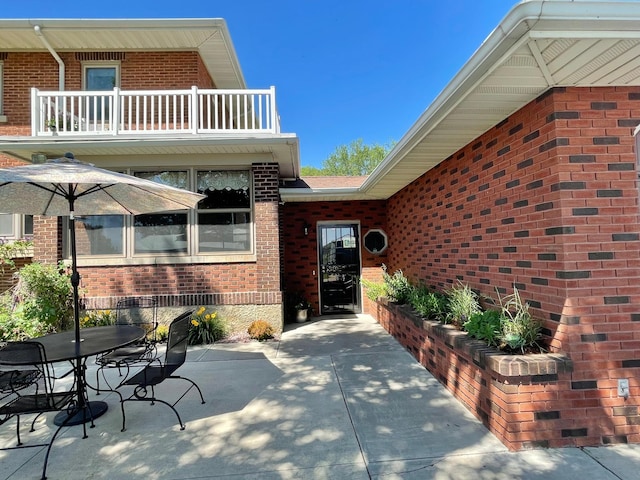 doorway to property featuring a balcony and a patio