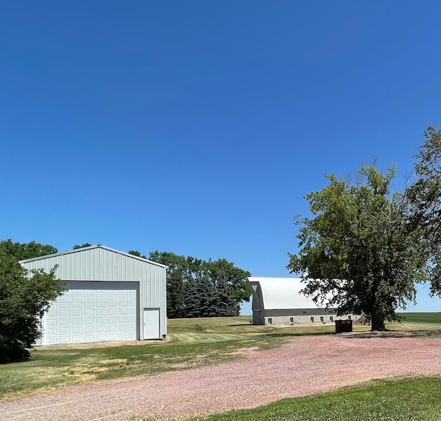 exterior space featuring a garage and an outdoor structure