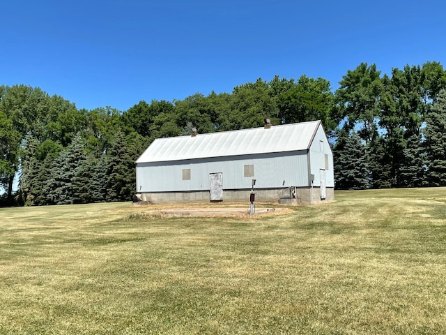 view of outbuilding featuring a lawn