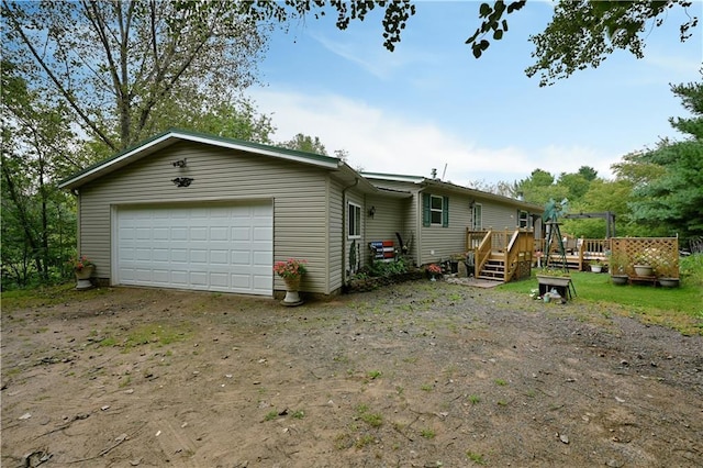 view of front of home with a garage and a deck