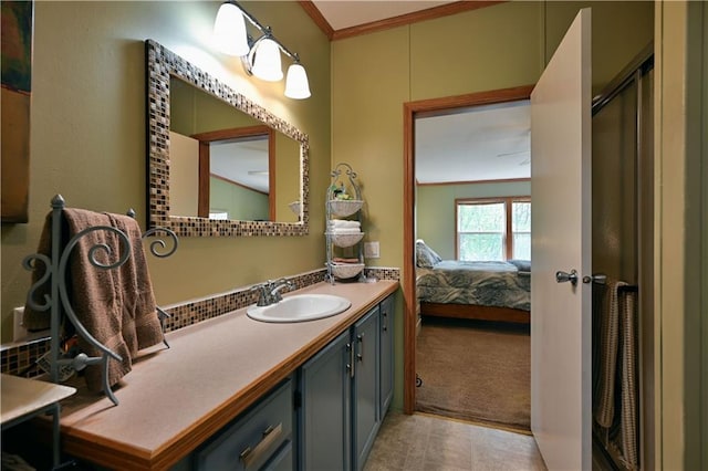 bathroom with ornamental molding, an enclosed shower, and vanity