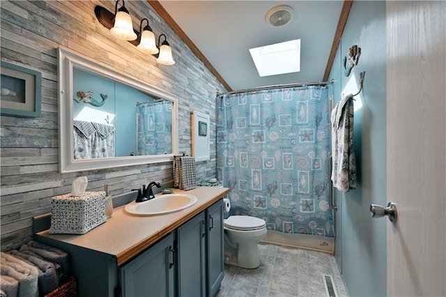 bathroom with vanity, a skylight, wooden walls, toilet, and a shower with curtain