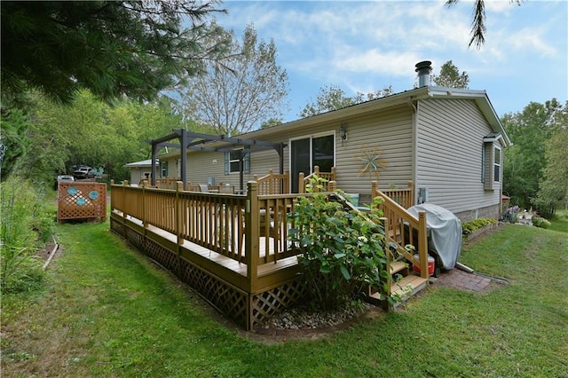 back of house featuring a wooden deck and a lawn