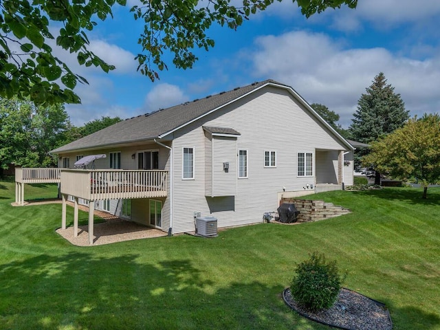 rear view of property featuring central AC, a yard, and a deck