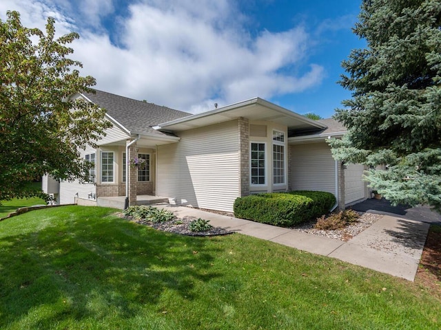 view of front of house with a garage and a front lawn