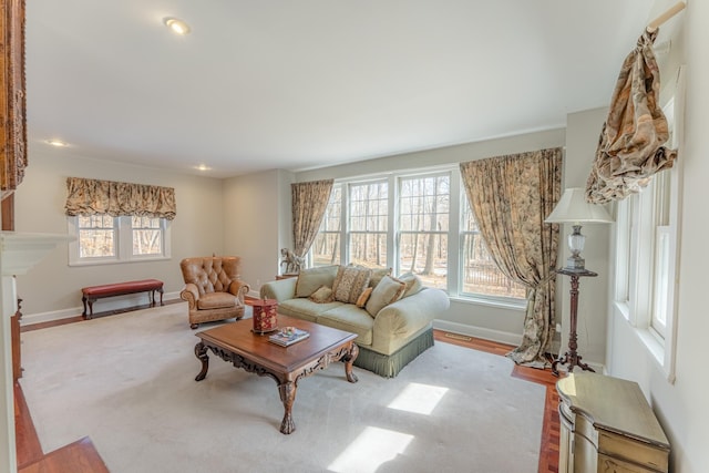 living area with recessed lighting, a fireplace, and baseboards