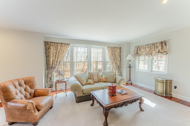 living area featuring light wood-style floors and baseboards