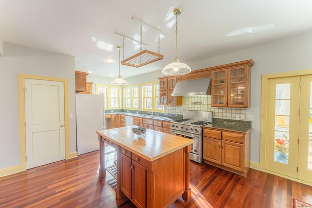 kitchen with dark wood-type flooring, butcher block countertops, white appliances, exhaust hood, and decorative backsplash