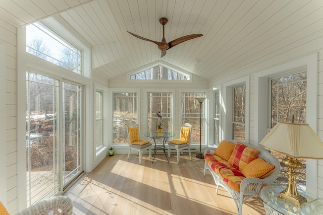 sunroom with a wealth of natural light, wooden ceiling, ceiling fan, and vaulted ceiling