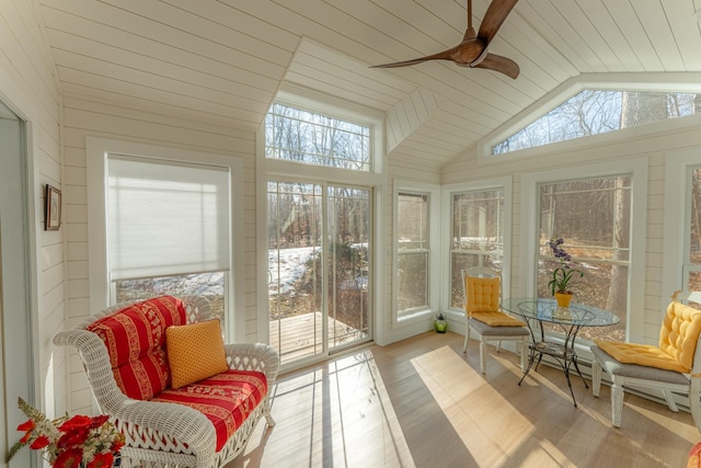 sunroom / solarium featuring plenty of natural light, a ceiling fan, and vaulted ceiling