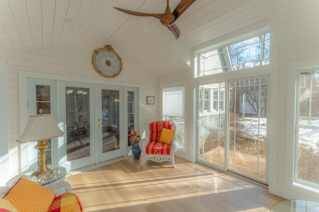 sunroom with plenty of natural light, french doors, a ceiling fan, and lofted ceiling