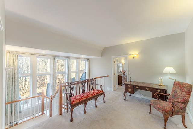 living area with carpet, an upstairs landing, and baseboards