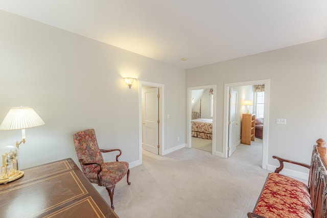 sitting room with light colored carpet and baseboards