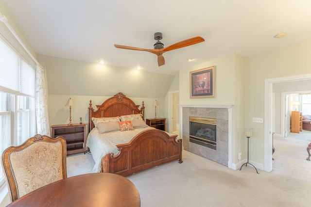 carpeted bedroom with a ceiling fan, baseboards, lofted ceiling, recessed lighting, and a high end fireplace