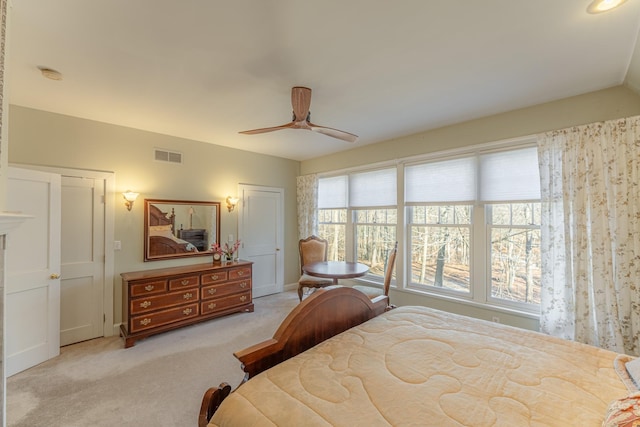 carpeted bedroom with visible vents and ceiling fan