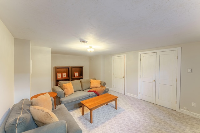 living room with light carpet, a textured ceiling, and baseboards