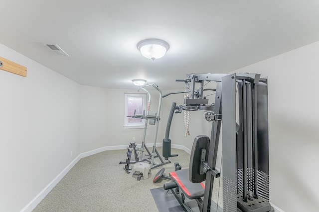 exercise room with visible vents and baseboards