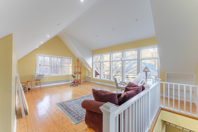 living area featuring light wood-type flooring, baseboards, and vaulted ceiling