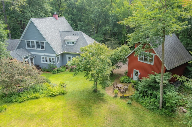 birds eye view of property with a view of trees