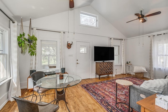 living room featuring ceiling fan, hardwood / wood-style flooring, and high vaulted ceiling